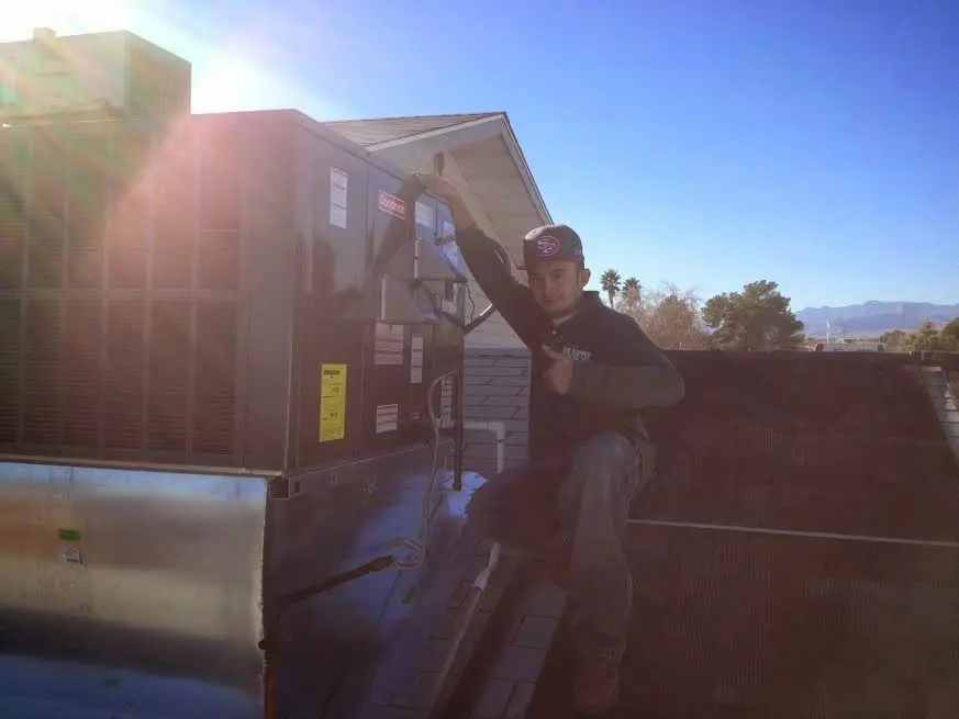 HVAC technician performing HVAC Inspection on a rooftop unit in New Hope